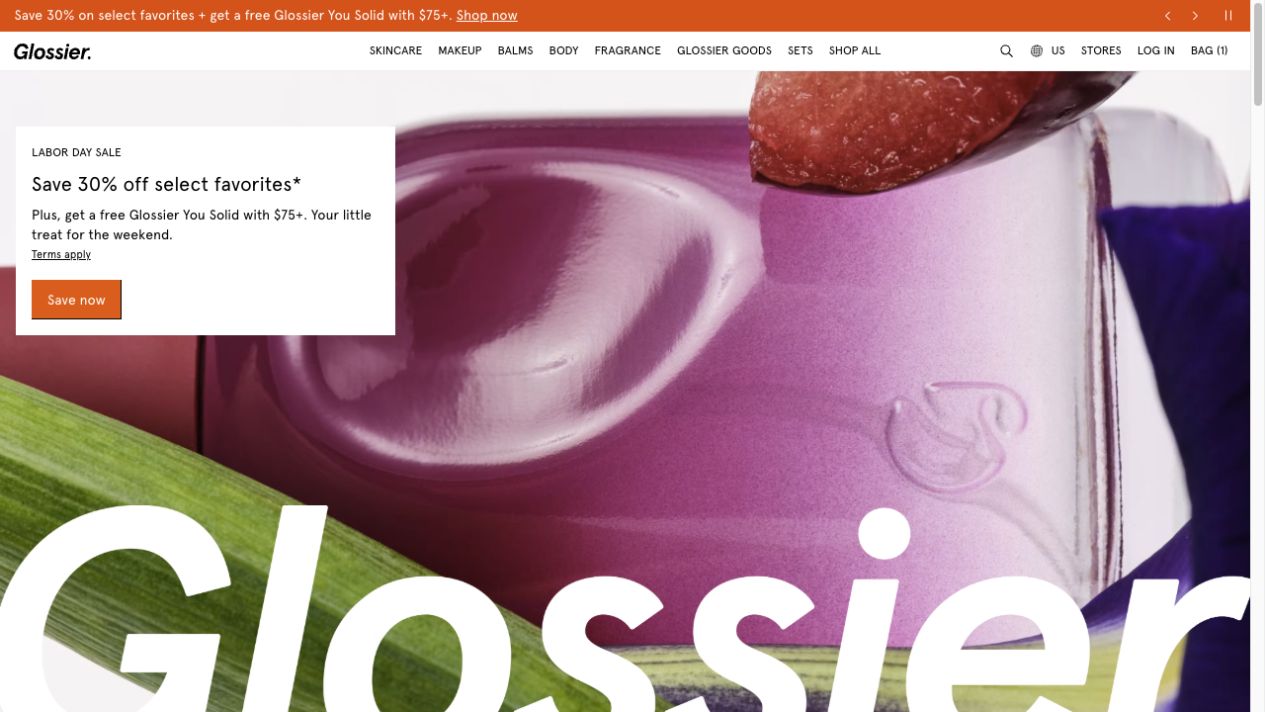 Glossier homepage showing a priority offer, product-led creative, category navigation, and a direct shopping call to action